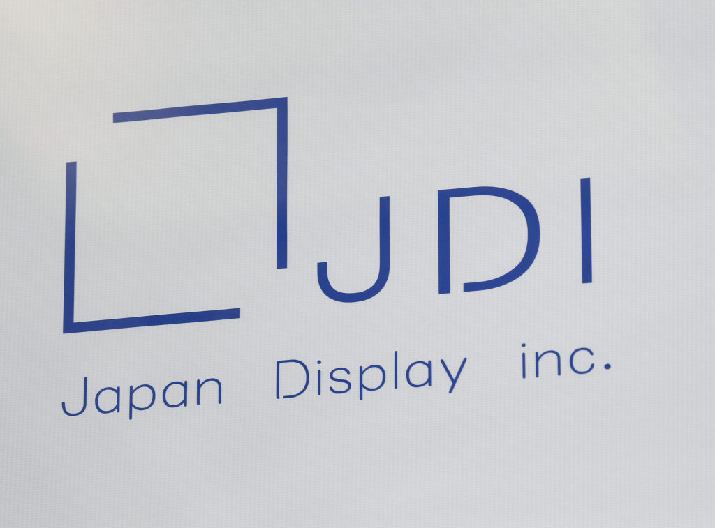 The Japan Display Inc. logo is seen on a replica of a glass panel used for liquid-crystal display (LCD) panels, displayed at the company's plant in Mobara, Chiba Prefecture, Japan, on Monday, March 17, 2014. Japan Display, a supplier of screens for Apple Inc. devices, and its investors will raise about 318.5 billion yen ($3.1 billion) after pricing its initial public offering at the bottom of the range. Photographer: Kiyoshi Ota/Bloomberg